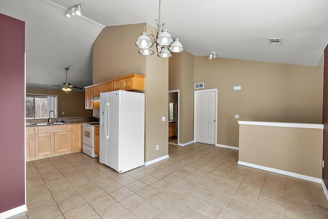 kitchen with sink, light tile patterned floors, light brown cabinets, white appliances, and range hood