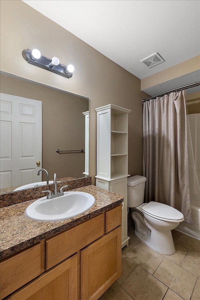 full bathroom with shower / tub combo with curtain, vanity, toilet, and tile patterned floors