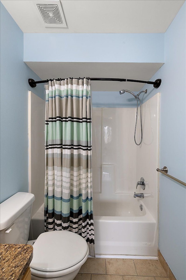 bathroom featuring shower / tub combo with curtain, tile patterned flooring, and toilet