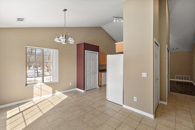 interior space with light tile patterned floors, high vaulted ceiling, and a chandelier