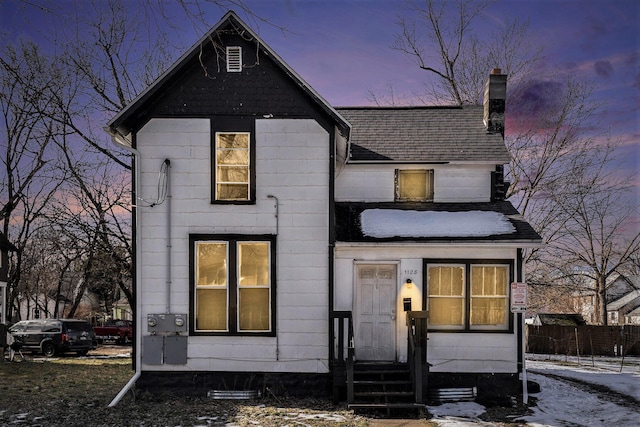 view of back house at dusk