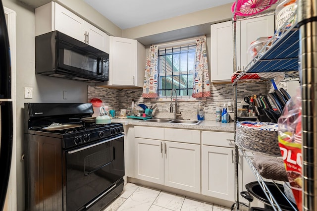 kitchen featuring decorative backsplash, sink, white cabinets, and black appliances