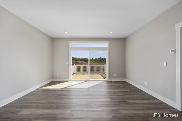 empty room with dark wood-type flooring