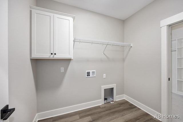 clothes washing area with hookup for a washing machine, dark hardwood / wood-style floors, and cabinets