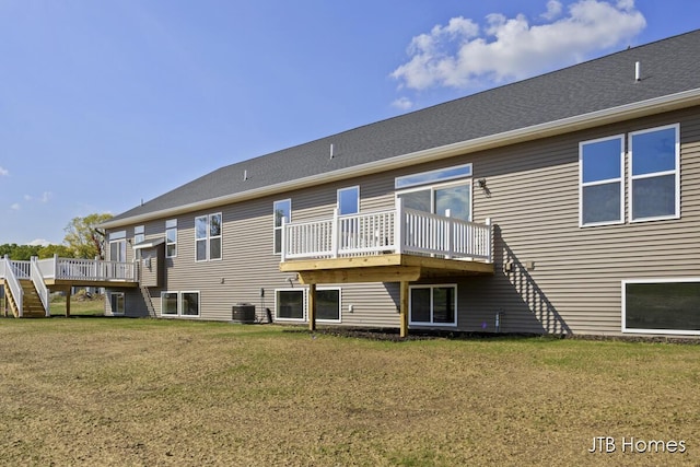 back of property featuring a yard, a deck, and central air condition unit