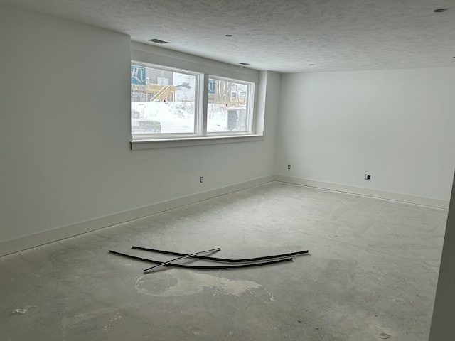 spare room featuring a textured ceiling