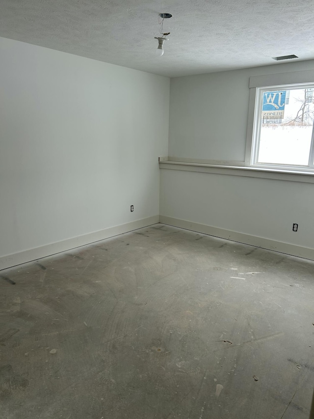 empty room with a textured ceiling