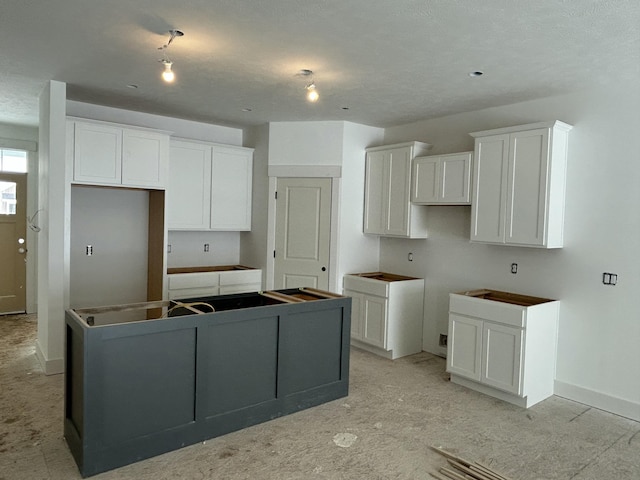 kitchen with a center island and white cabinets