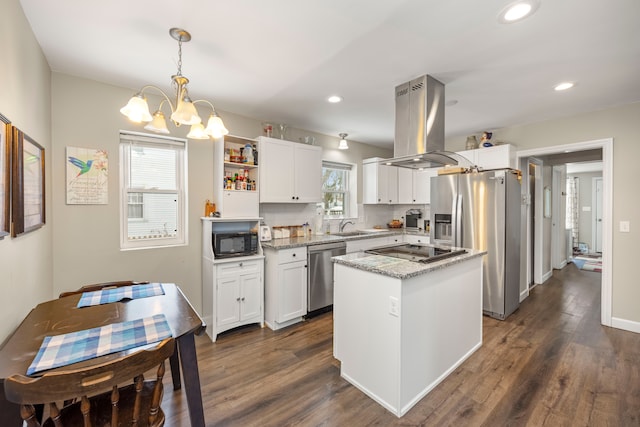 kitchen with white cabinets, island range hood, decorative light fixtures, and black appliances