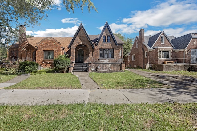 tudor-style house with a front yard