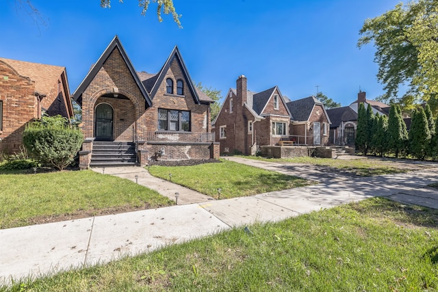 tudor home with a front yard