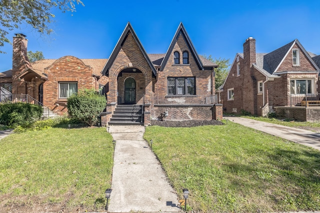 tudor-style house with a front lawn