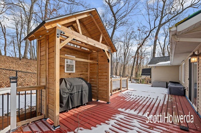 snow covered deck with area for grilling