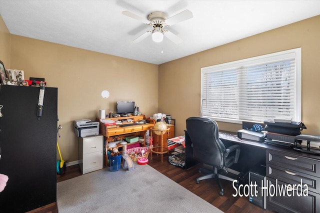 home office with dark wood-type flooring and ceiling fan