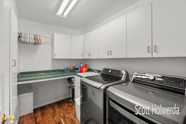 clothes washing area with sink, cabinets, dark hardwood / wood-style floors, and washer and dryer