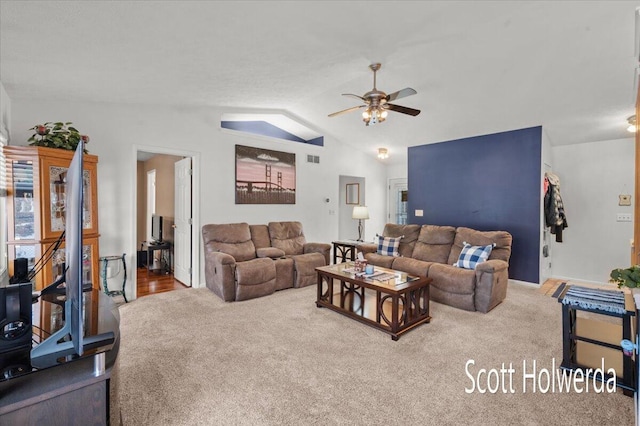 living room with vaulted ceiling, carpet flooring, and ceiling fan