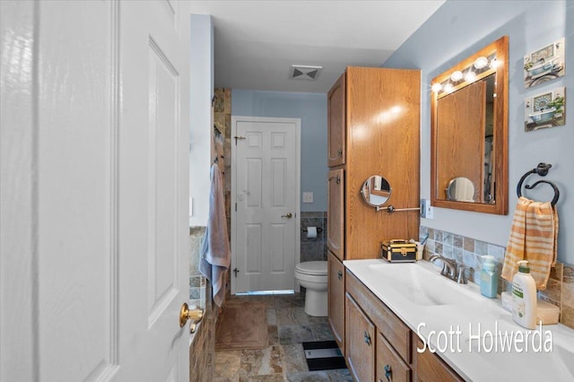 bathroom featuring vanity and toilet