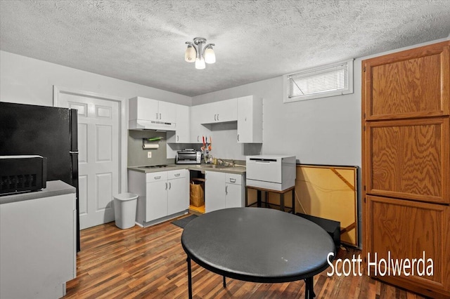 kitchen featuring dark wood-type flooring, sink, white cabinets, and a textured ceiling