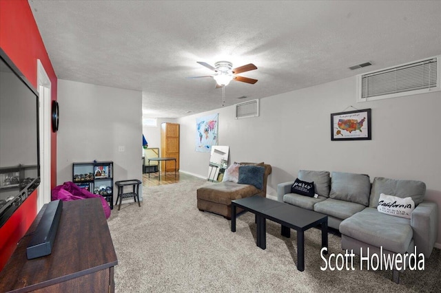 carpeted living room with ceiling fan and a textured ceiling