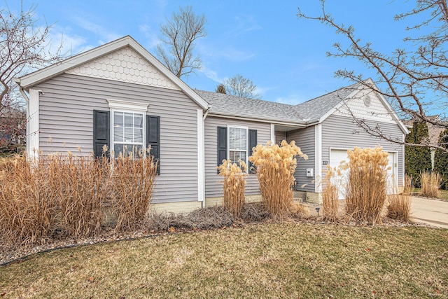 view of side of property featuring a garage and a yard