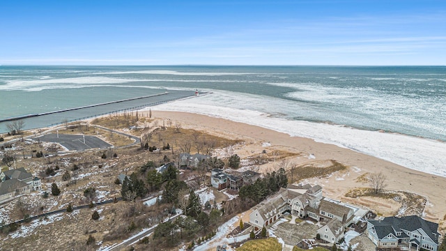 birds eye view of property with a beach view and a water view