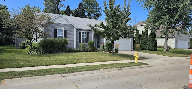 view of front facade featuring a garage and a front lawn