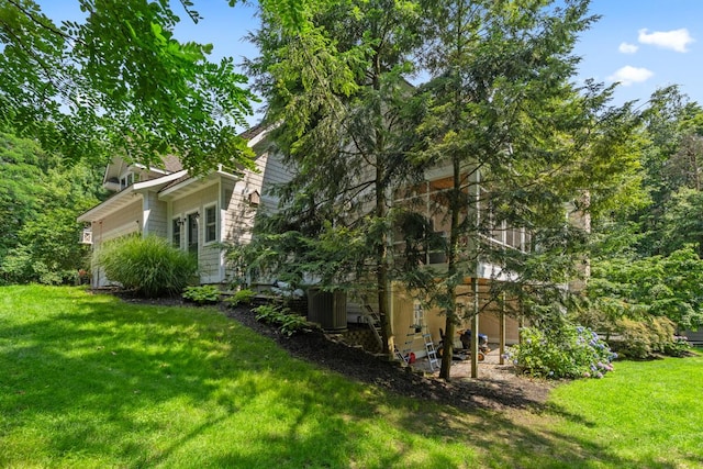 view of side of home featuring a lawn