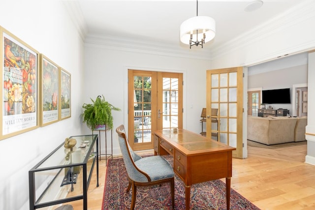 home office featuring french doors, crown molding, light hardwood / wood-style floors, and a notable chandelier