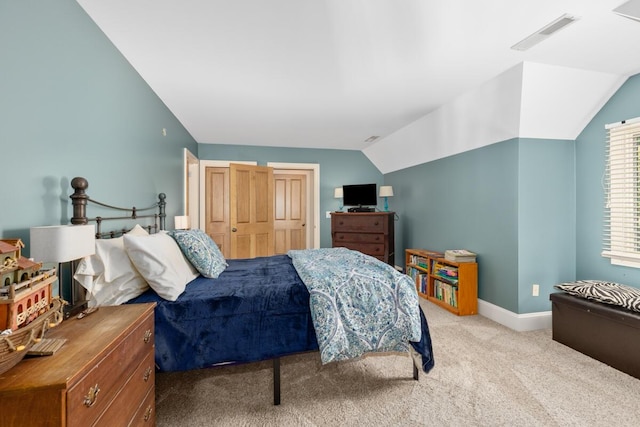 carpeted bedroom with vaulted ceiling