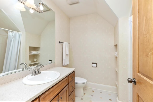 bathroom featuring vanity, vaulted ceiling, toilet, and a shower with shower curtain