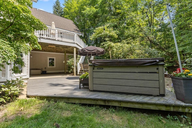 wooden deck featuring a hot tub