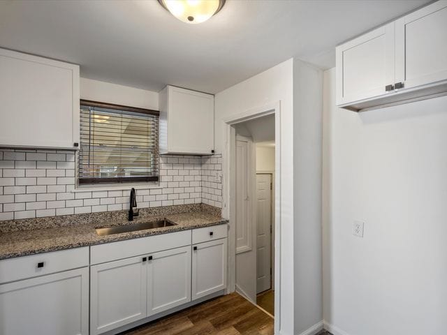 kitchen featuring sink and white cabinets