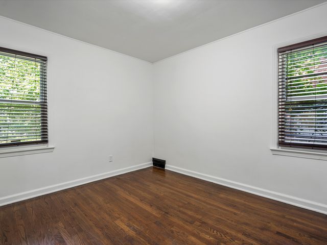 unfurnished room featuring dark hardwood / wood-style floors