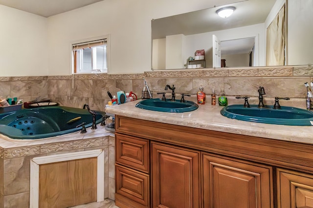 bathroom featuring tiled tub and vanity