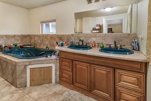 bathroom with vanity and tiled tub