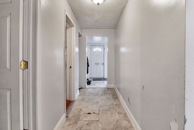 corridor with a textured ceiling