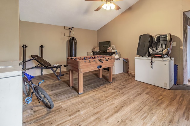 rec room with ceiling fan, lofted ceiling, and light hardwood / wood-style floors