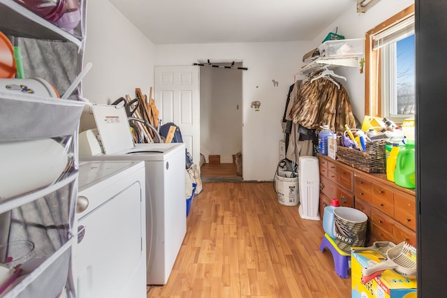 washroom with independent washer and dryer and light wood-type flooring