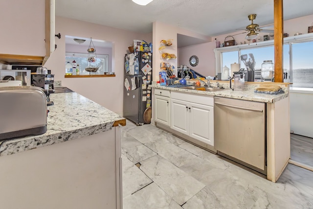 kitchen with sink, ceiling fan, dishwasher, white cabinetry, and black fridge