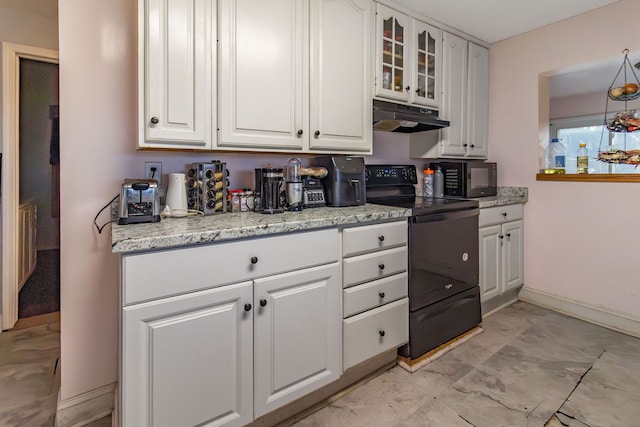 kitchen featuring white cabinets, light stone counters, and black appliances