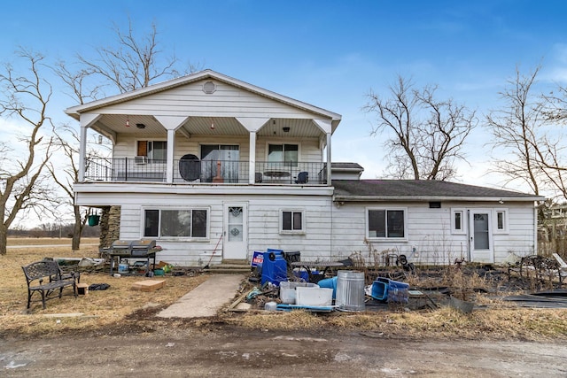 back of house with a balcony