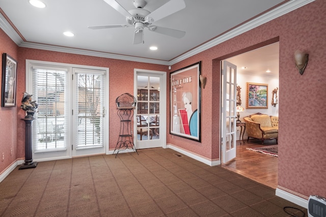 entryway with crown molding, ceiling fan, and dark carpet