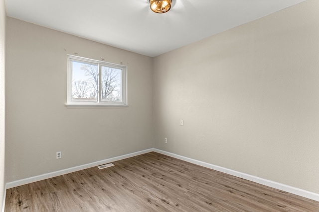 spare room with hardwood / wood-style flooring