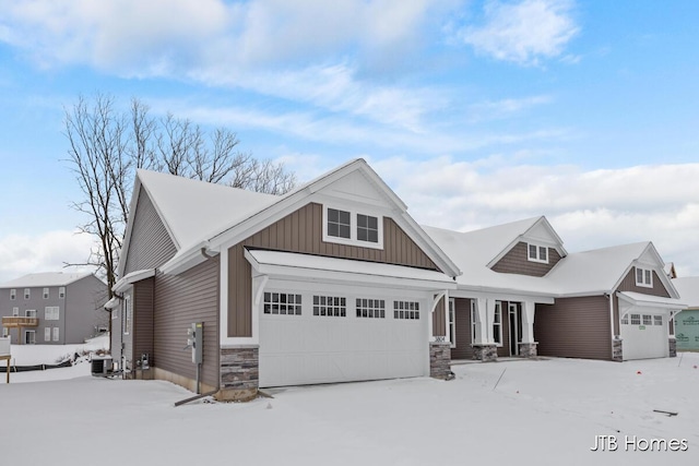 craftsman house featuring a garage and central air condition unit