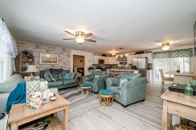 living room featuring ceiling fan and light hardwood / wood-style floors