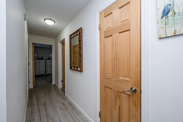 corridor with light hardwood / wood-style flooring