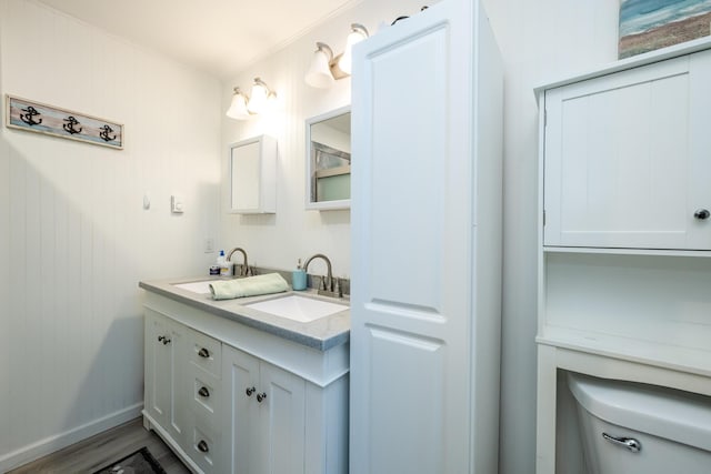 bathroom with hardwood / wood-style flooring, vanity, and toilet