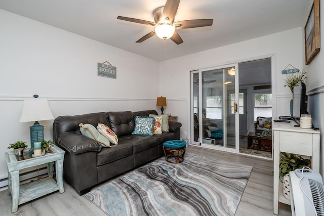 living room featuring ceiling fan and light wood-type flooring