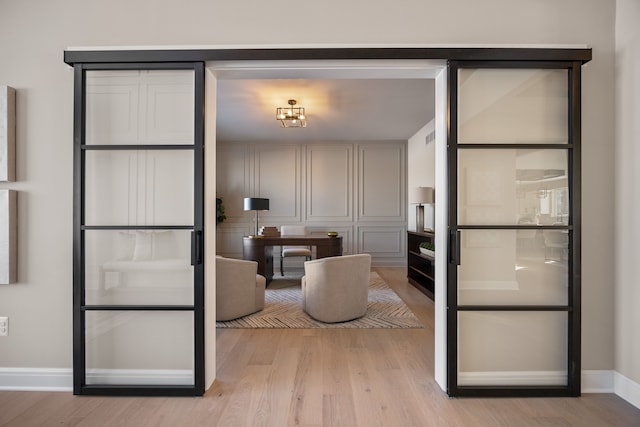 interior space featuring light wood finished floors and baseboards