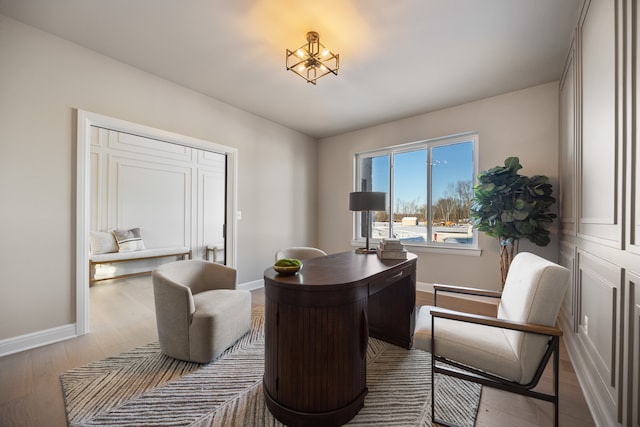 office area with light wood-type flooring and baseboards